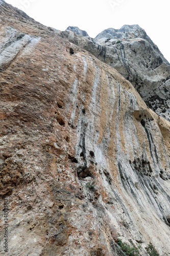 high imposing steep limestone wall overhanging rock without peop
