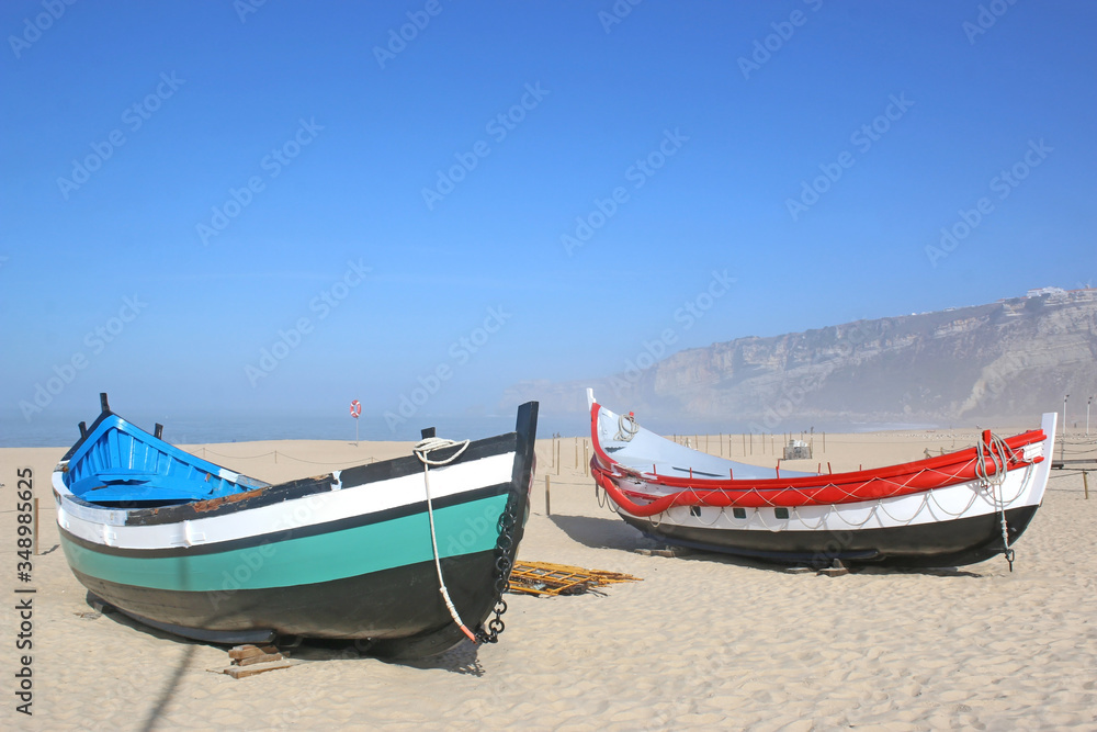 Traditional fishing boats on Nazare beach, Portugal Traditional fishing boats on Nazare beach, Portugal