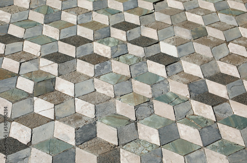 tiled old floor with tiles that create an optical effect of cube