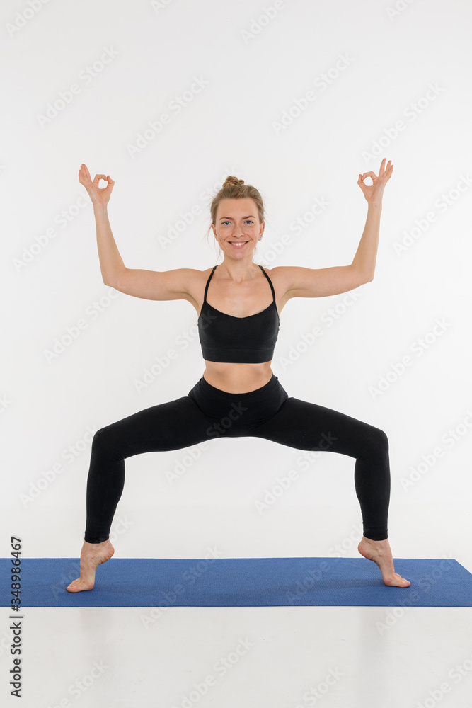 Sporty attractive young woman doing yoga practice on white background. Sporty attractive young woman doing yoga practice on white background.