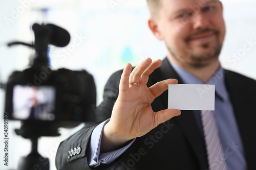 Bisnessman hold business card in hand photo