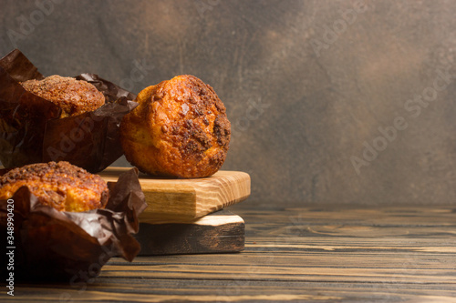 Homemade delicious muffins on wooden background close-up