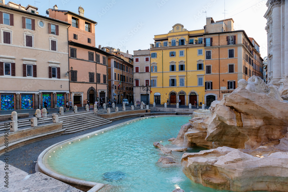 Rome, Italy - May 10, 2020: Trevi Fountain desolate and without tourists and with very few citizens due to restrictions on the coronavirus pandemic.