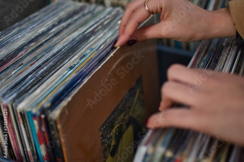 Chica mirando vinilos en una tienda de música.