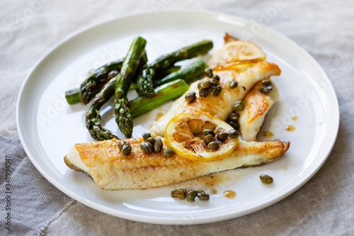 Lemon sole with butter and capers sauce and asparagus
