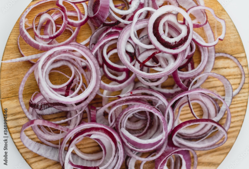 Red onion rings on a wooden board isolated and white background.Close up. Cooking concept 