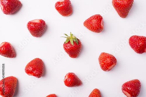 Top above overhead view photo of peeled strawberries with one whole in the center isolated on white background