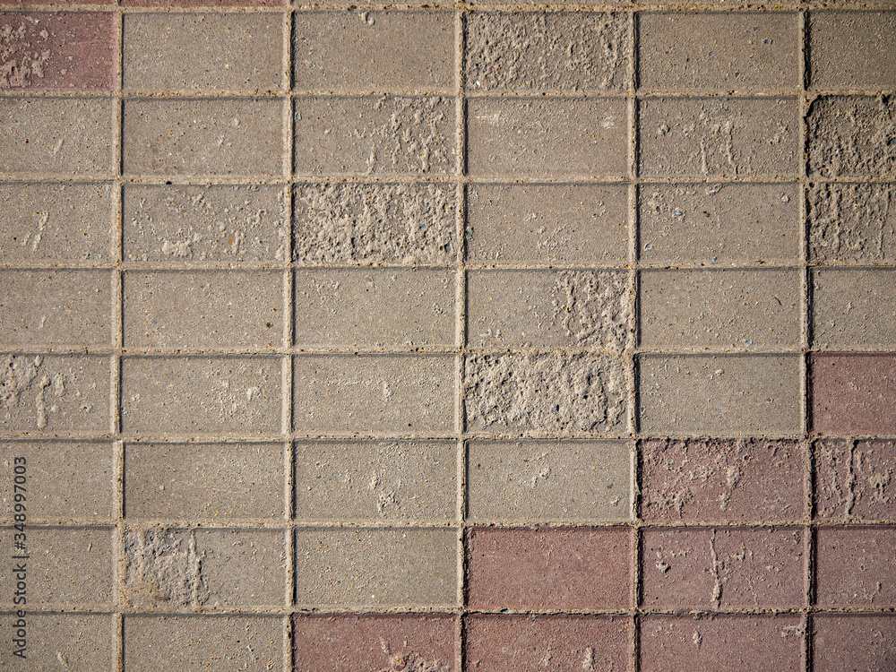 Fototapeta premium Background looks like a fragment of stone pavement with a vignette. Detail of architecture and temporary building structures.