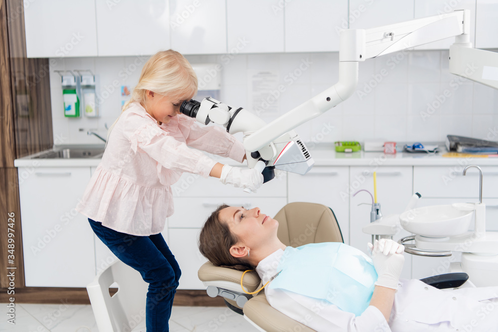 A child acting as a dentist doctor playing with dental tools, having silicone gloves on A child acting as a dentist doctor playing with dental tools, having silicone gloves on
