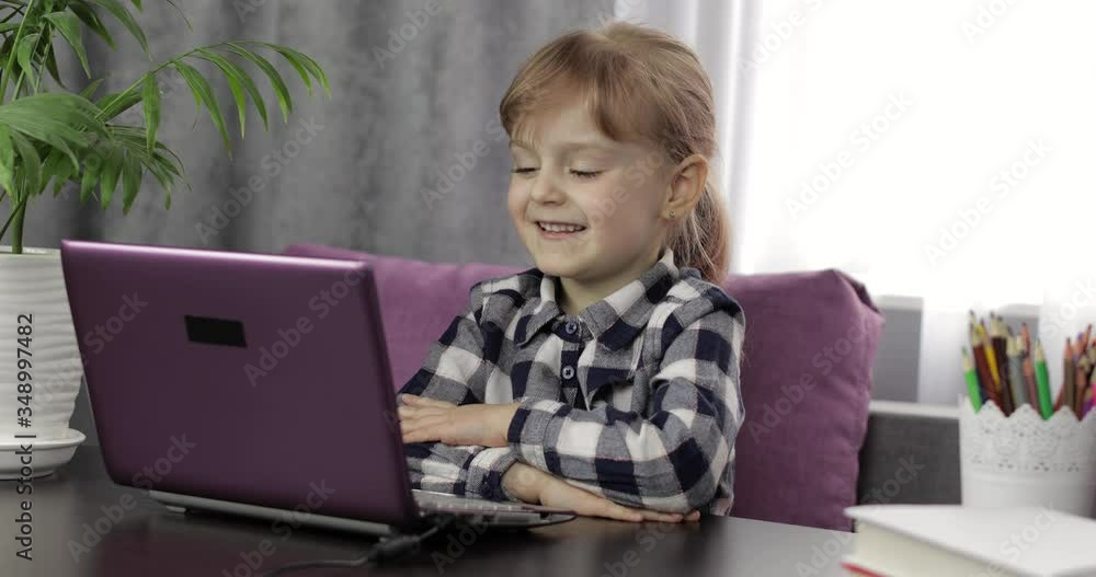 Girl learning online lessons using digital laptop computer. Distance education Girl learning online lessons using digital laptop computer. Distance education