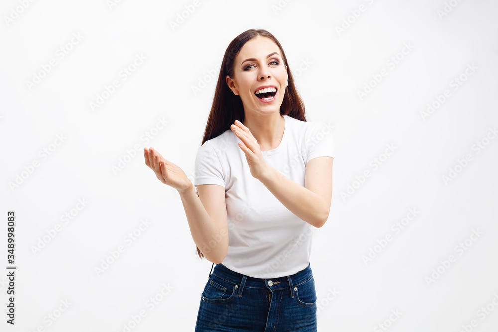 Beautiful brunette girl smiling with the teeth, wearing a white t-shirt and blue jeans Beautiful brunette girl smiling with the teeth, wearing a white t-shirt and blue jeans