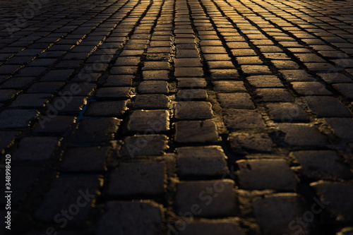 Rain water on Cobblestone street at night