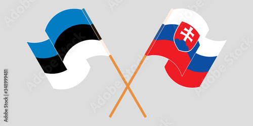 Crossed and waving flags of Slovakia and Estonia