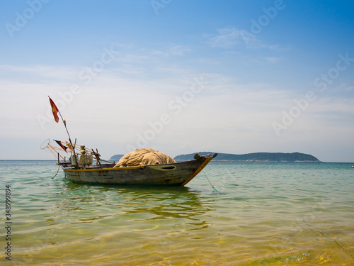 Beautiful view of a boat in the water in a sunny day, in Vietnam. Hoian is recognized as a World Heritage Site by UNESCO photo