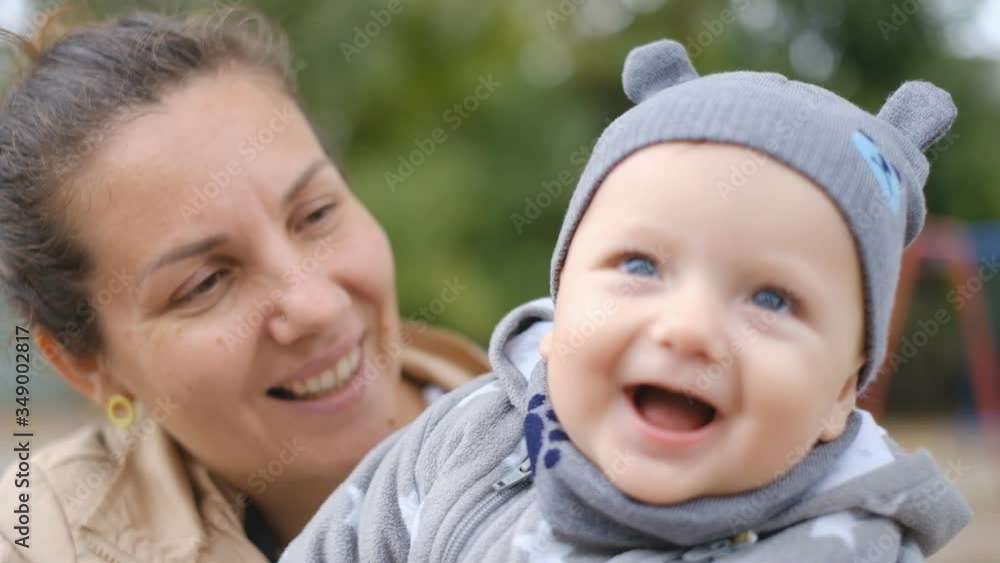 Mother with baby having fun in the park in autumn. Mother with baby having fun in the park in autumn.