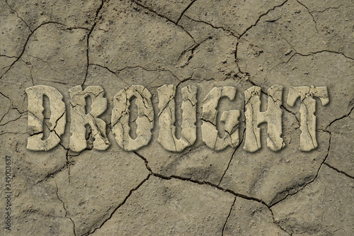 Drought. Lettering word from dry cracked soil on dried ground with cracks