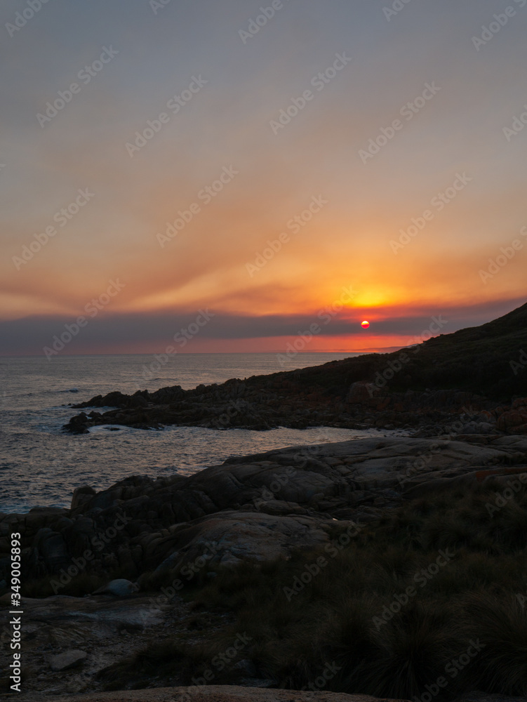 Sunset at rocky beachside view ocean waves Sunset at rocky beachside view ocean waves