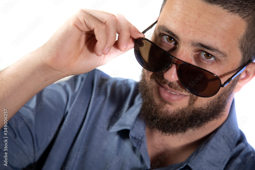 Obraz premium Man looking over sunglasses on white background 