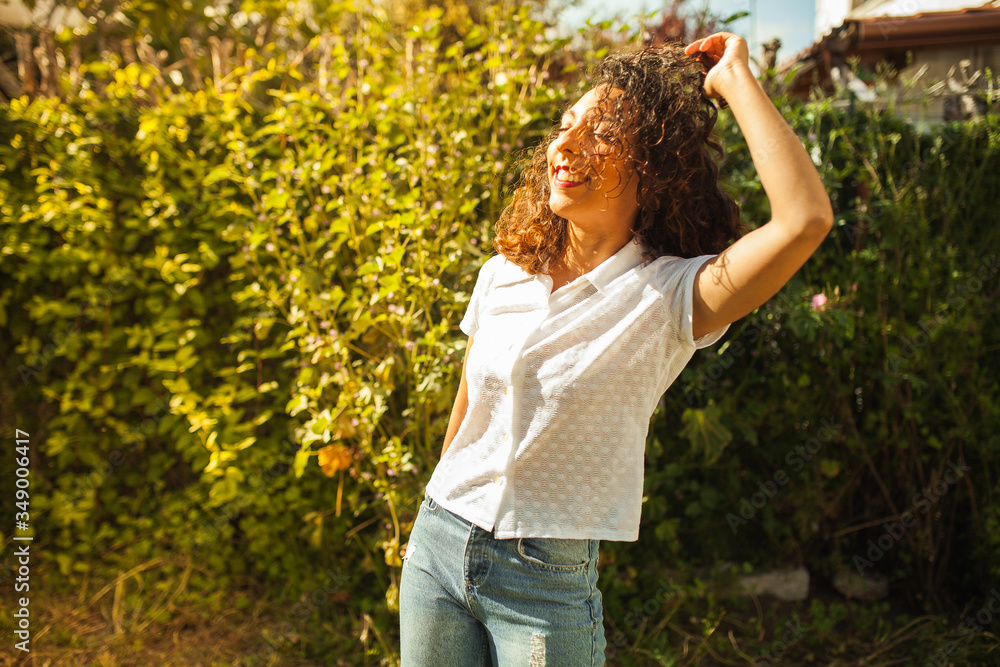 Beautiful happy young woman enjoying at the park in a sunny day,smiling Beautiful happy young woman enjoying at the park in a sunny day,smiling