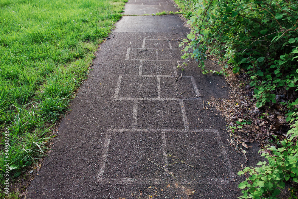 Old, overgrown path with hopscotch board Old, overgrown path with hopscotch board