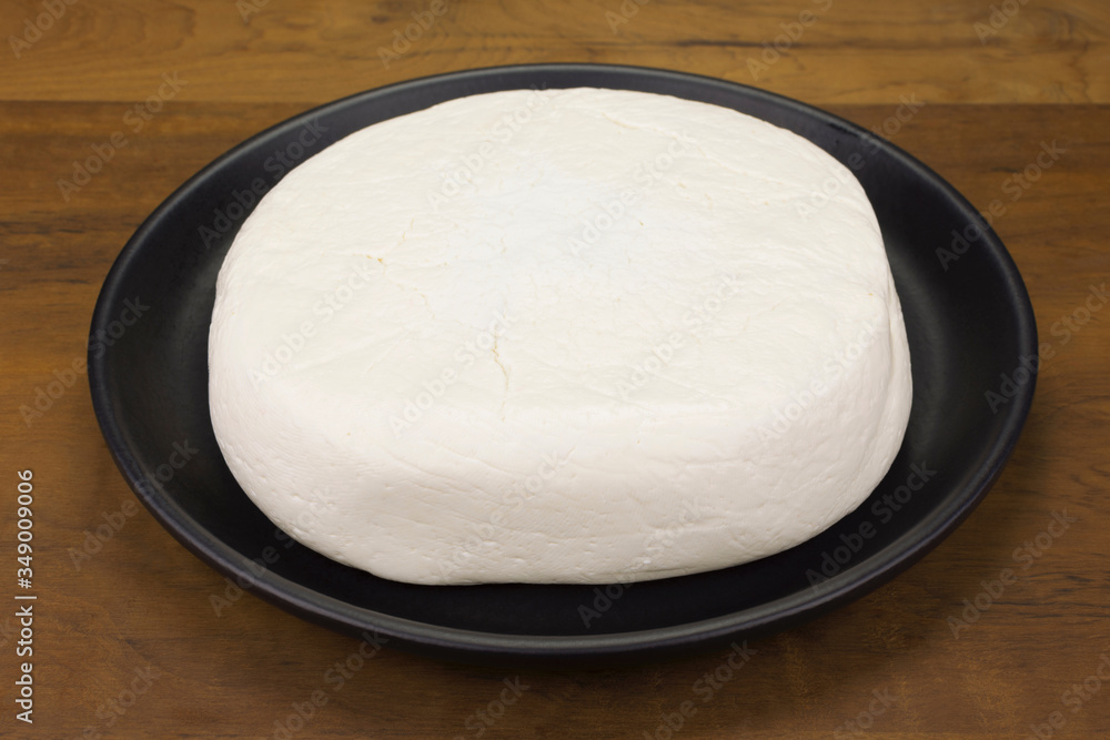 Buffalo fresh cheese made in Serra da Canastra, in wood background Buffalo fresh cheese made in Serra da Canastra, in wood background