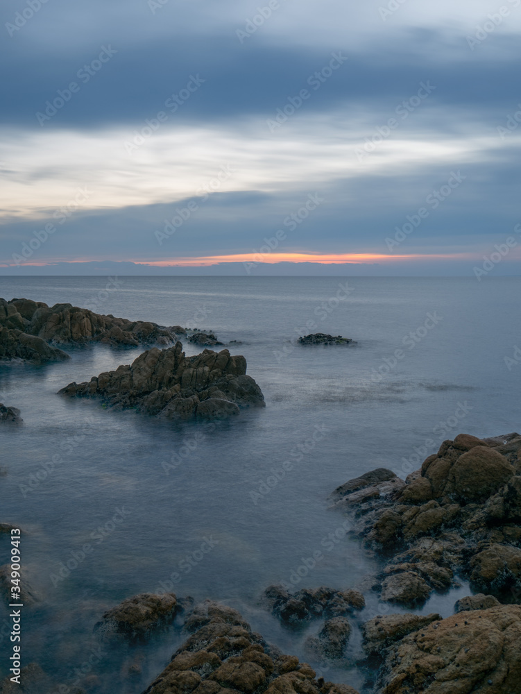 long exposure of sea and rocks at sunset 