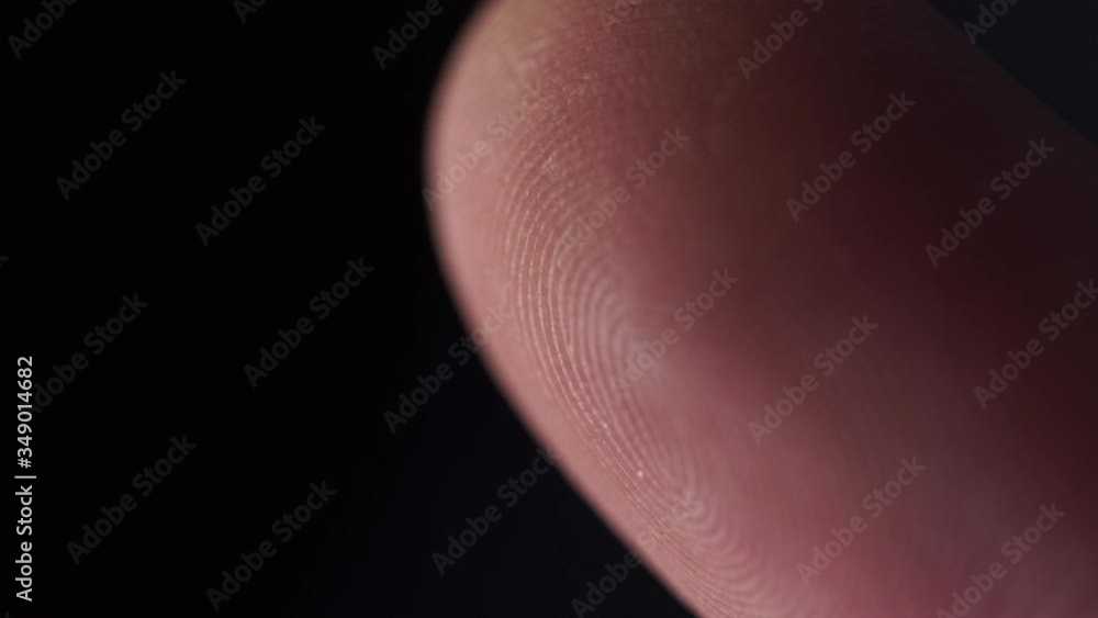 EXTREME CLOSE UP MACRO: Detail of fingerprint on Caucasian index finger. White person's skin pattern and texture on fingertips. White man's finger prints EXTREME CLOSE UP MACRO: Detail of fingerprint on Caucasian index finger. White person's skin pattern and texture on fingertips. White man's finger prints