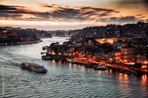 Porto  Portugal  old town cityscape and the Douro River with traditional Rabelo boats  seen from the Dom Luis bridge after sunset