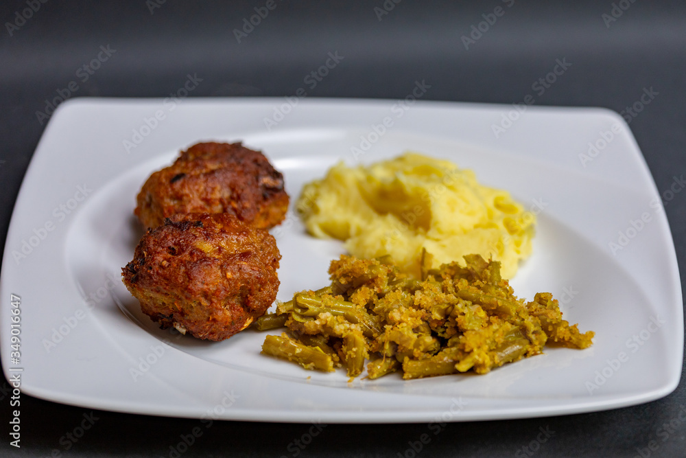 close up meatballs,mashed and green beans potatoes in plate close up meatballs,mashed and green beans potatoes in plate