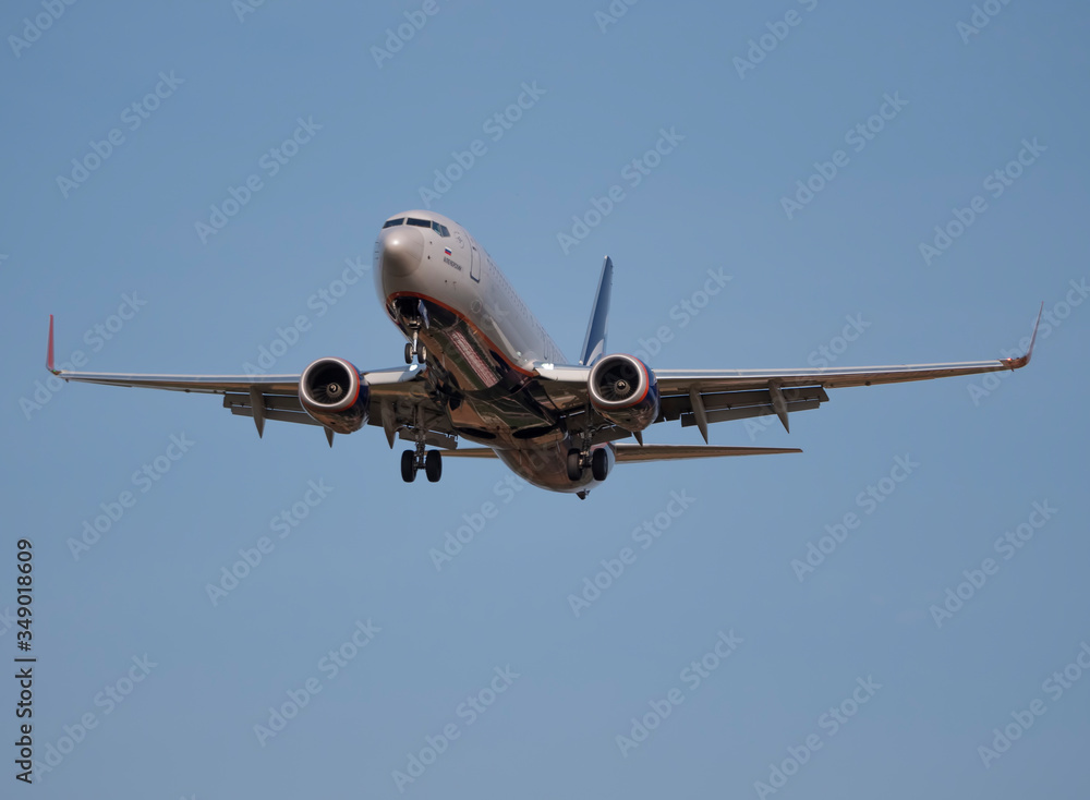 MOSCOW , RUSSIA, June 10, 2019: The Commercial passenger airplane flying overhead on sunny day on June 10, 2019 in Moscow, Russia MOSCOW , RUSSIA, June 10, 2019: The Commercial passenger airplane flying overhead on sunny day on June 10, 2019 in Moscow, Russia