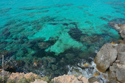 Clear turquoise water near the rocky shore. © neprolet