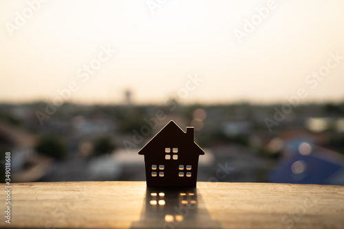 House model on wood table. Real estate agent offer house, property insurance and security, affordable housing concepts photo