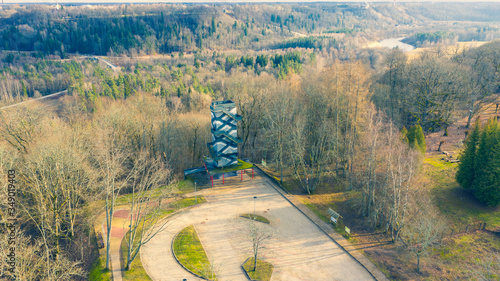 Beautiful panoramic aerial view photo from flying drone on Krimulda observation toweron a sunny winter day without snow against the background of forests and Sigulda. Krimulda, Latvia photo