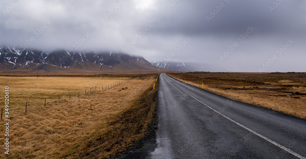 Highway countryside straight empty road and snowy mountains Iceland