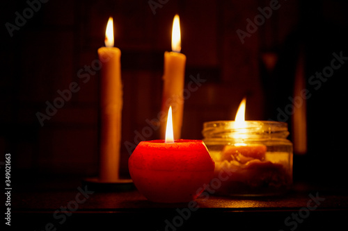 Candle on dark background. Candle in low key. Candle flame at night closeup