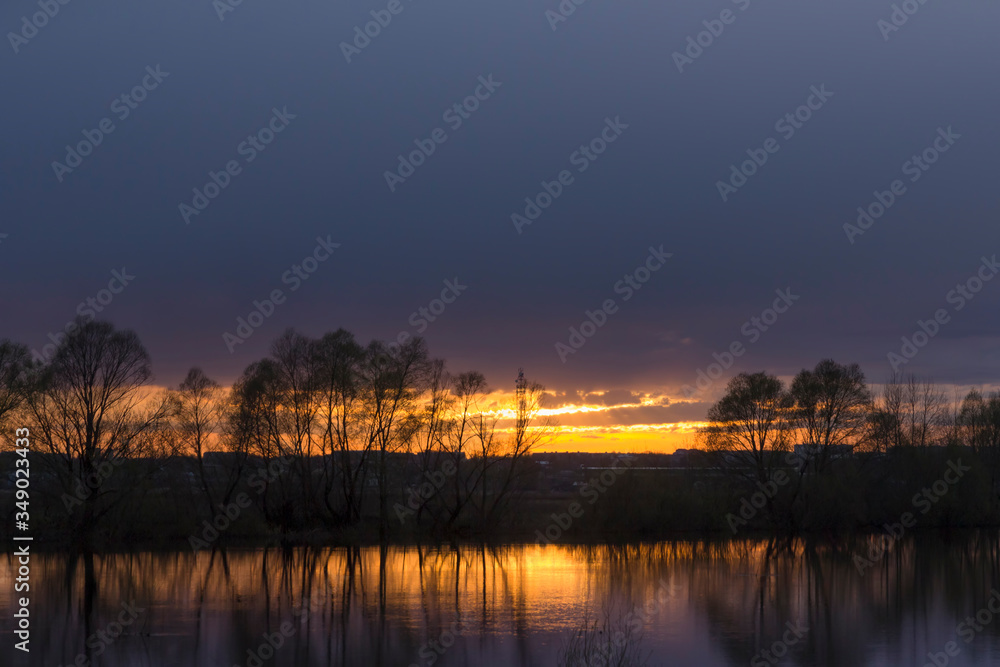 Summer evening and sunset on a forest lake