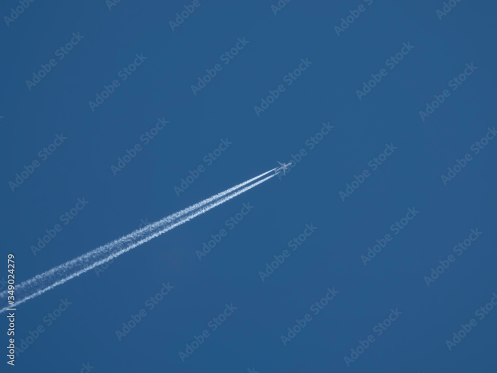 Airplane flies against a background of blue sky Airplane flies against a background of blue sky