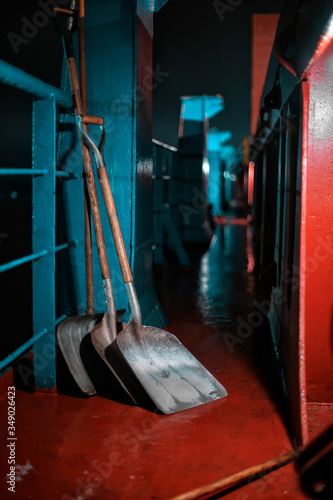 A working tool stands on the deck of a cargo ship. Portside lighting along the entire ship. Shovels. Cargo ship. photo