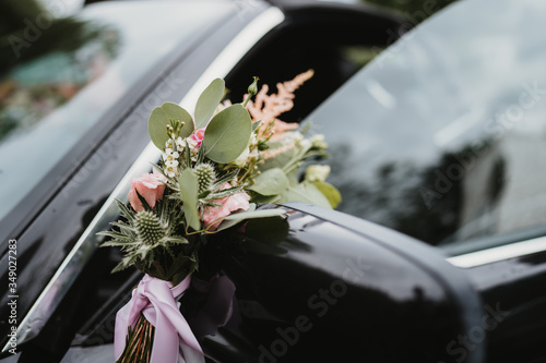 photo of a wedding car mirror with flowers