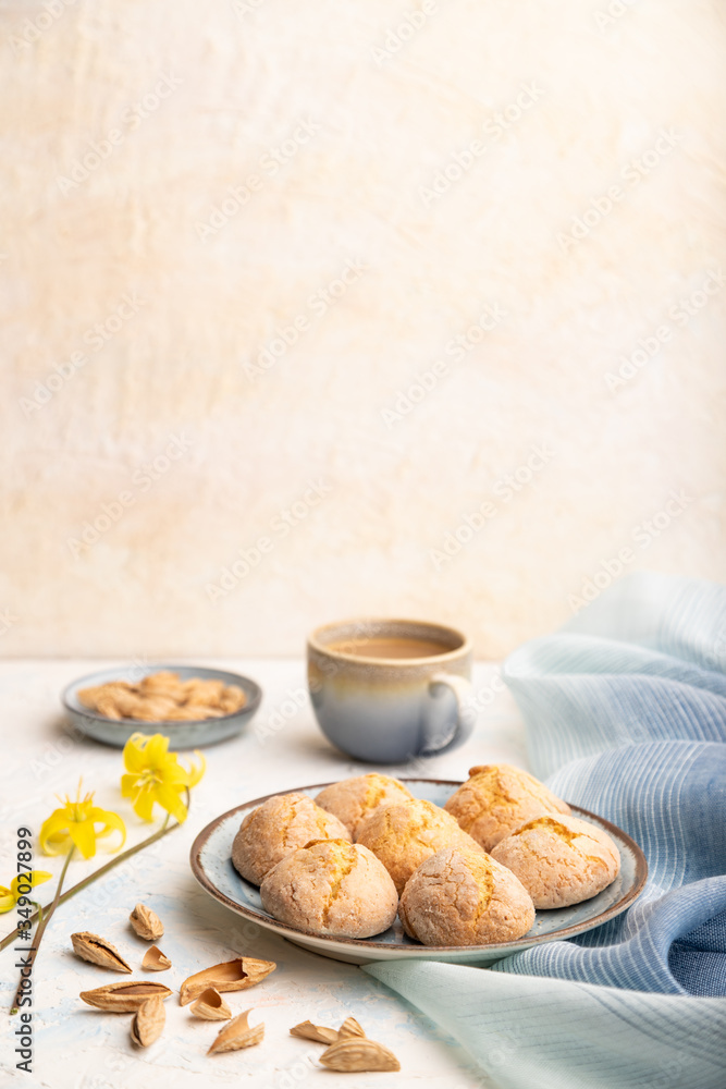Almond cookies and a cup of coffee on a white concrete background Side view, selective focus, copy space. Almond cookies and a cup of coffee on a white concrete background Side view, selective focus, copy space.