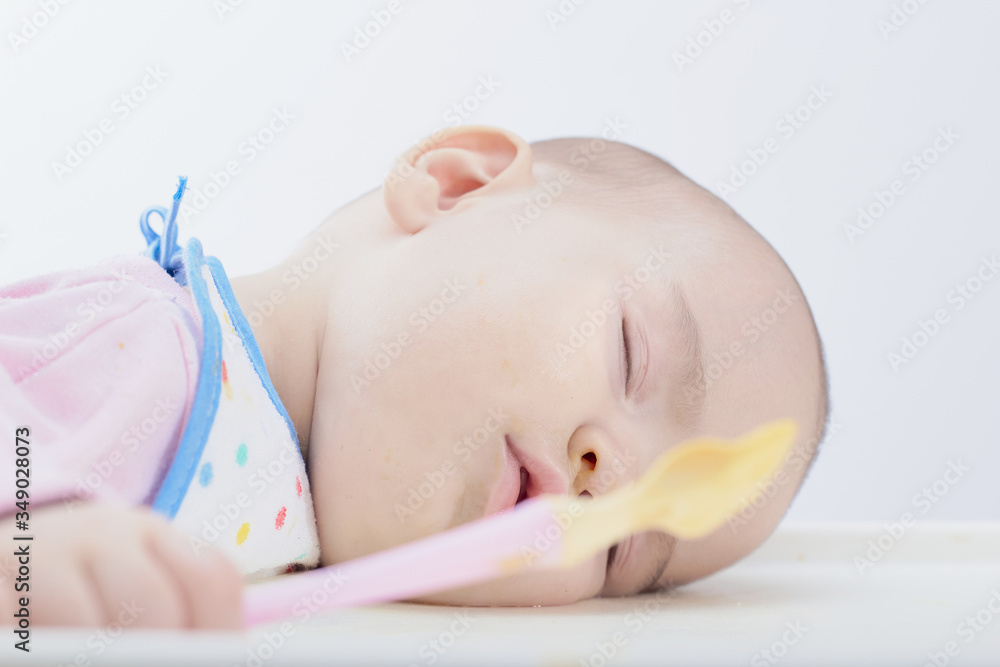 sleeping baby with spoon in his hands fell asleep during eating sleeping baby with spoon in his hands fell asleep during eating