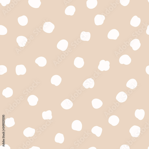 Vector seamless polka dots pattern in a chaotic manner. Hand drawn, doodle style. Design for fabric, wrapping, wallpaper, textile