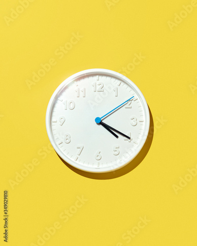 White Four-Twenty Clock Isolated on Yellow Background (ID: 349029810)
