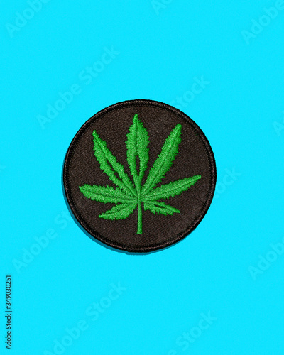 Cannabis Leaf Black Patch Isolated on Blue Background (ID: 349030251)