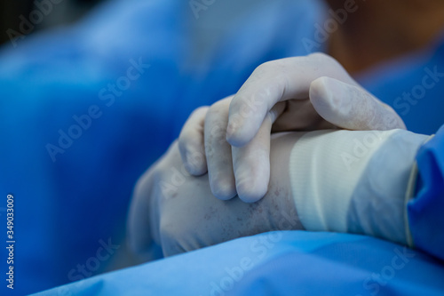Doctors hands with procedure gloves looking tired