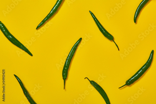 hot pepper pattern on a colored background. Top view, background for food, yellow color