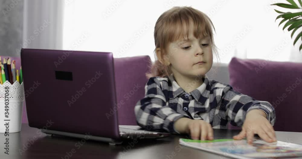 Girl studying online homework using digital laptop computer. Distance education Girl studying online homework using digital laptop computer. Distance education