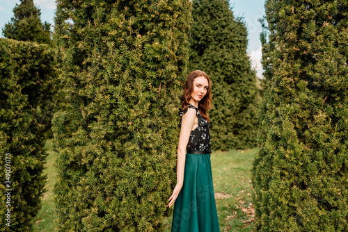 portrait of beautiful young girl in dress in the garden, female portrait outdoors