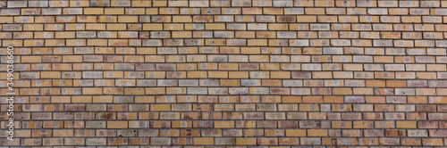 old brick wall of yellow color, wide panorama of masonry.