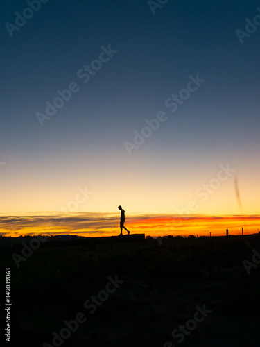 Man walking at sunset silhouette  © Pat Whelen